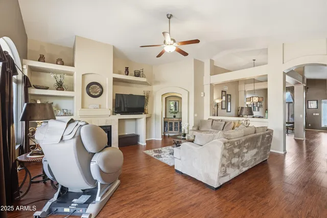 a living room with furniture and wooden floor