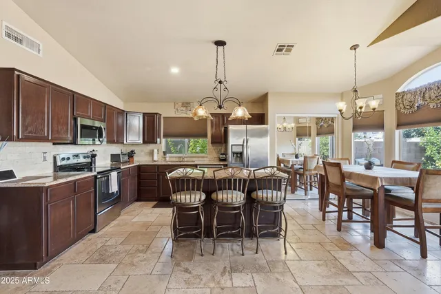 a large kitchen with a table and chairs