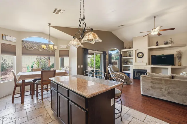 a view of a dining room with furniture a chandelier and wooden floor
