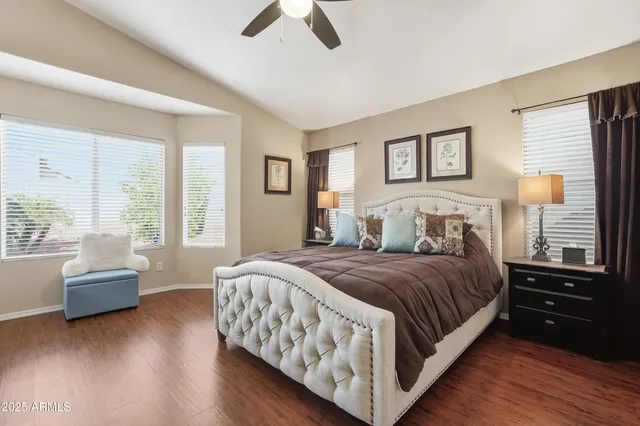 a bedroom with a bed and a couch next to a window