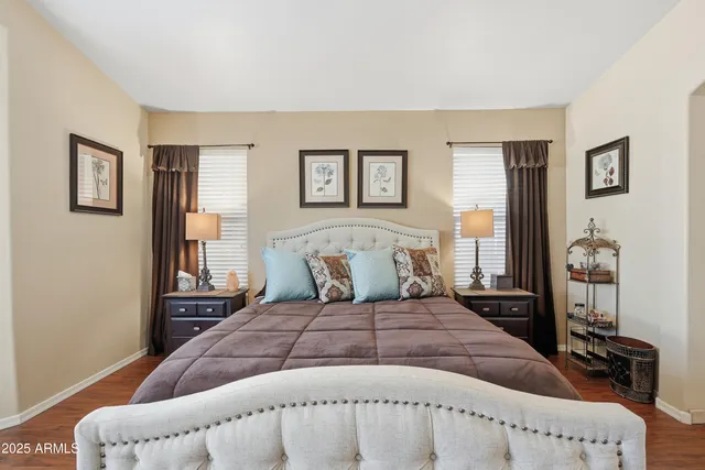 a bedroom with a bed and wooden floor