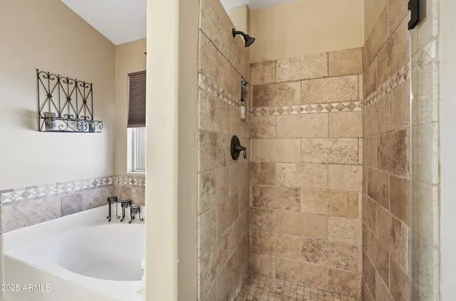 a bathroom with a bathtub and shower