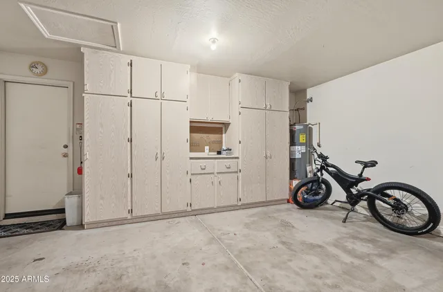 a view of a storage & utility room with a car parked