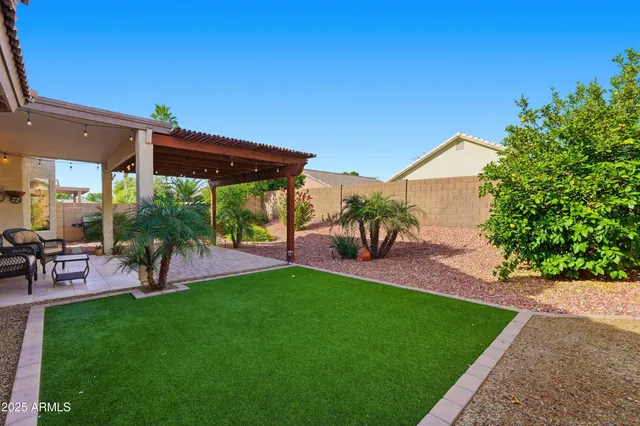 a view of a patio with table and chairs under an umbrella