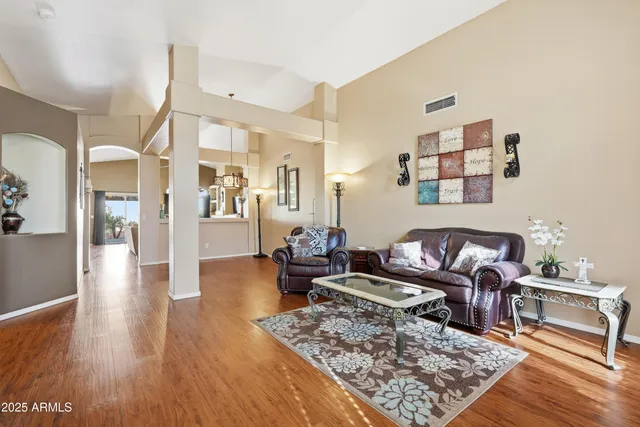 a living room with furniture and wooden floor