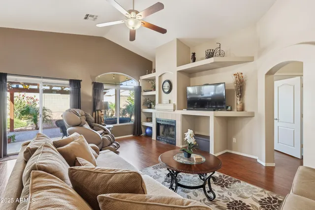a living room with furniture a fireplace and a flat screen tv