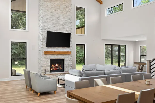 a spacious bedroom with a bed and a flat screen tv