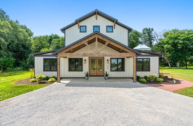 a front view of a house with a yard table and chairs