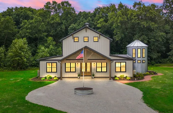 a front view of a house with a yard and porch