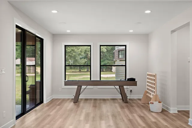 a front view of a house with a yard and trees