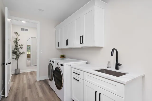 a living room with furniture a fireplace and a large window