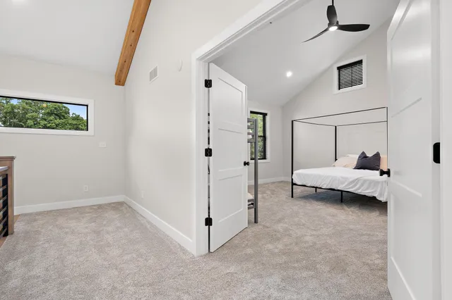 a view of a house with backyard and trees