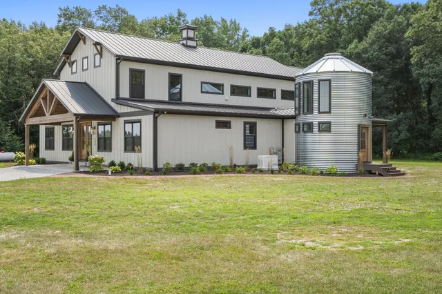 a living room with furniture fireplace and window