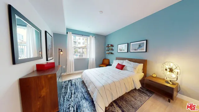 a bedroom with a bed and a lamp with window