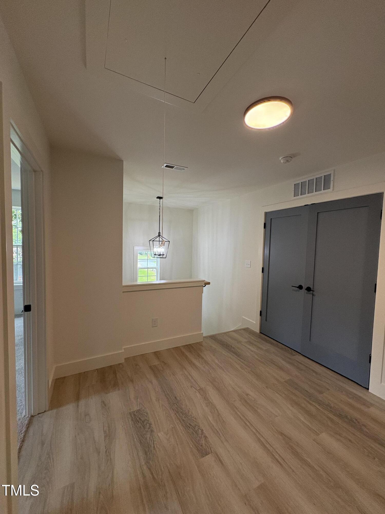 4511 Denfield Street Durham, NC 27704 - Photo 16 of 40 an empty room with wooden floor and windows