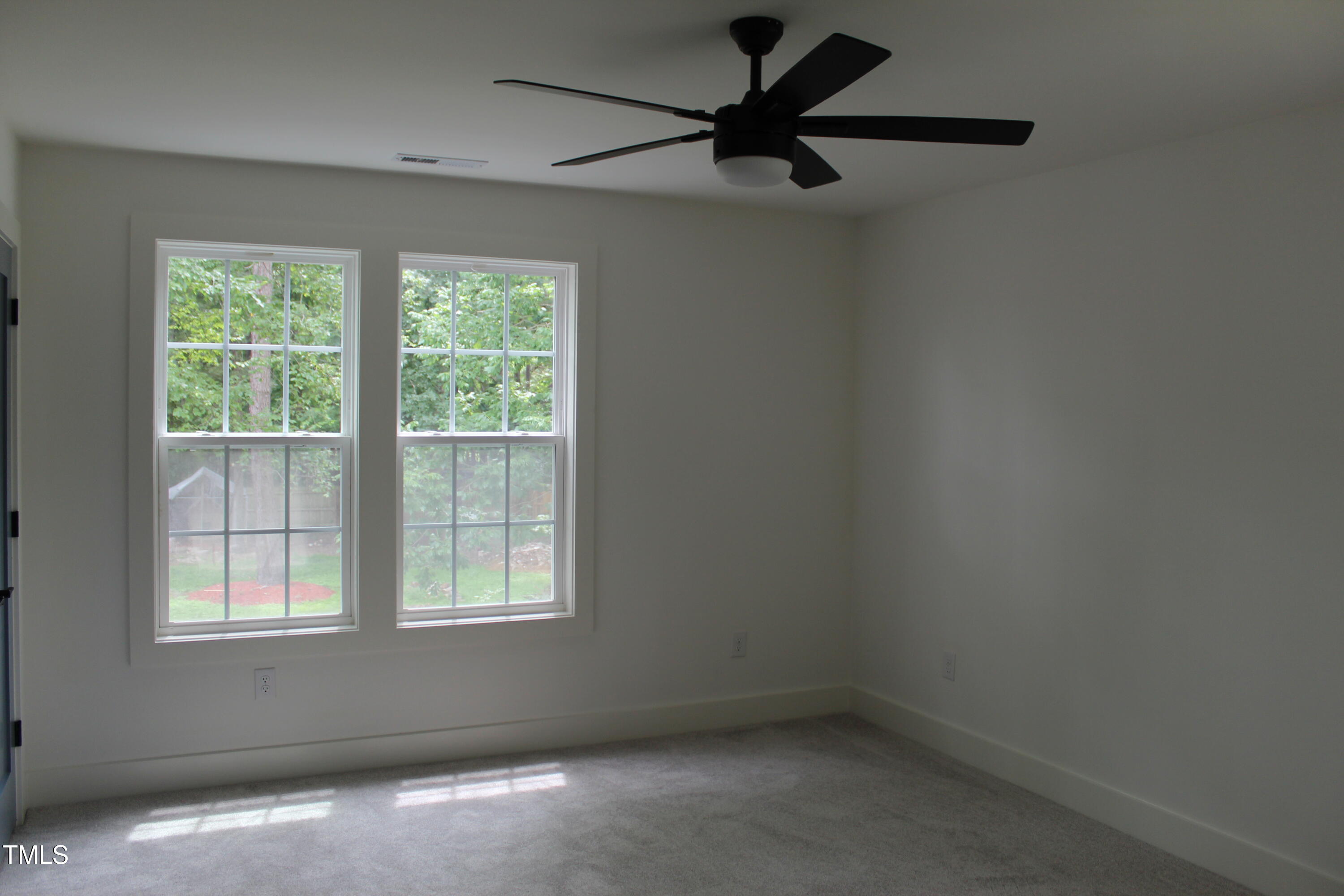 4511 Denfield Street Durham, NC 27704 - Photo 19 of 40 an empty room with a window and a fan