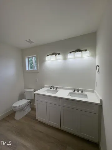 a bathroom with a sink toilet and mirror