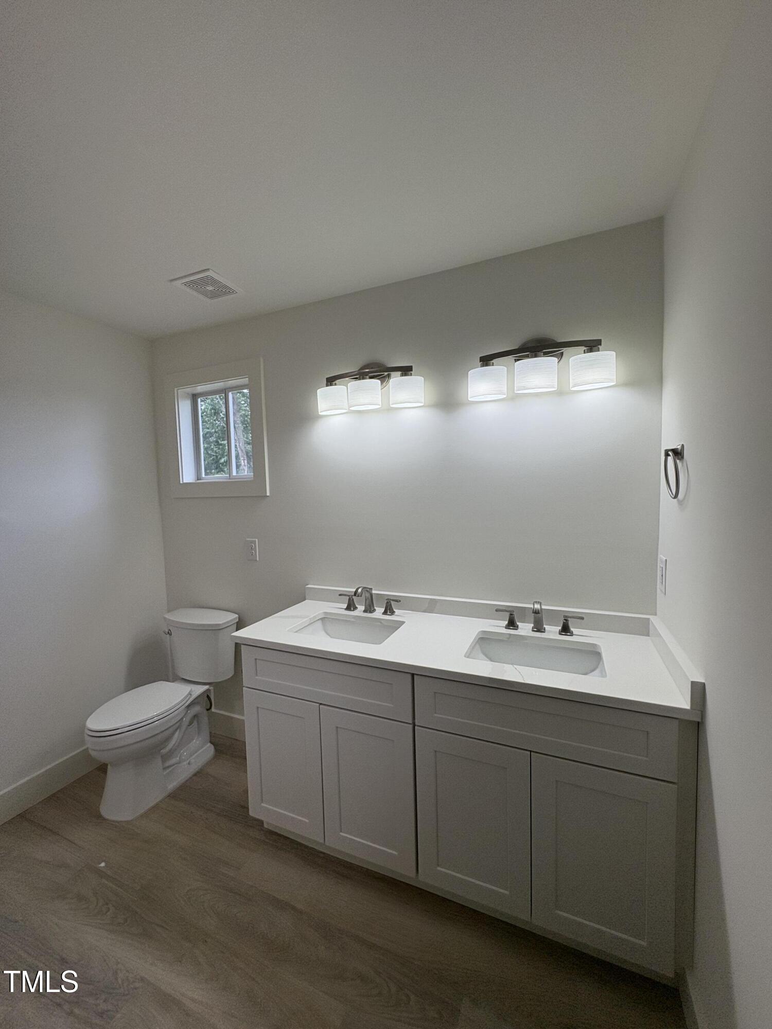 4511 Denfield Street Durham, NC 27704 - Photo 21 of 40 a bathroom with a sink toilet and mirror
