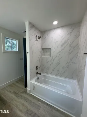 a bathroom with a bathtub and shower