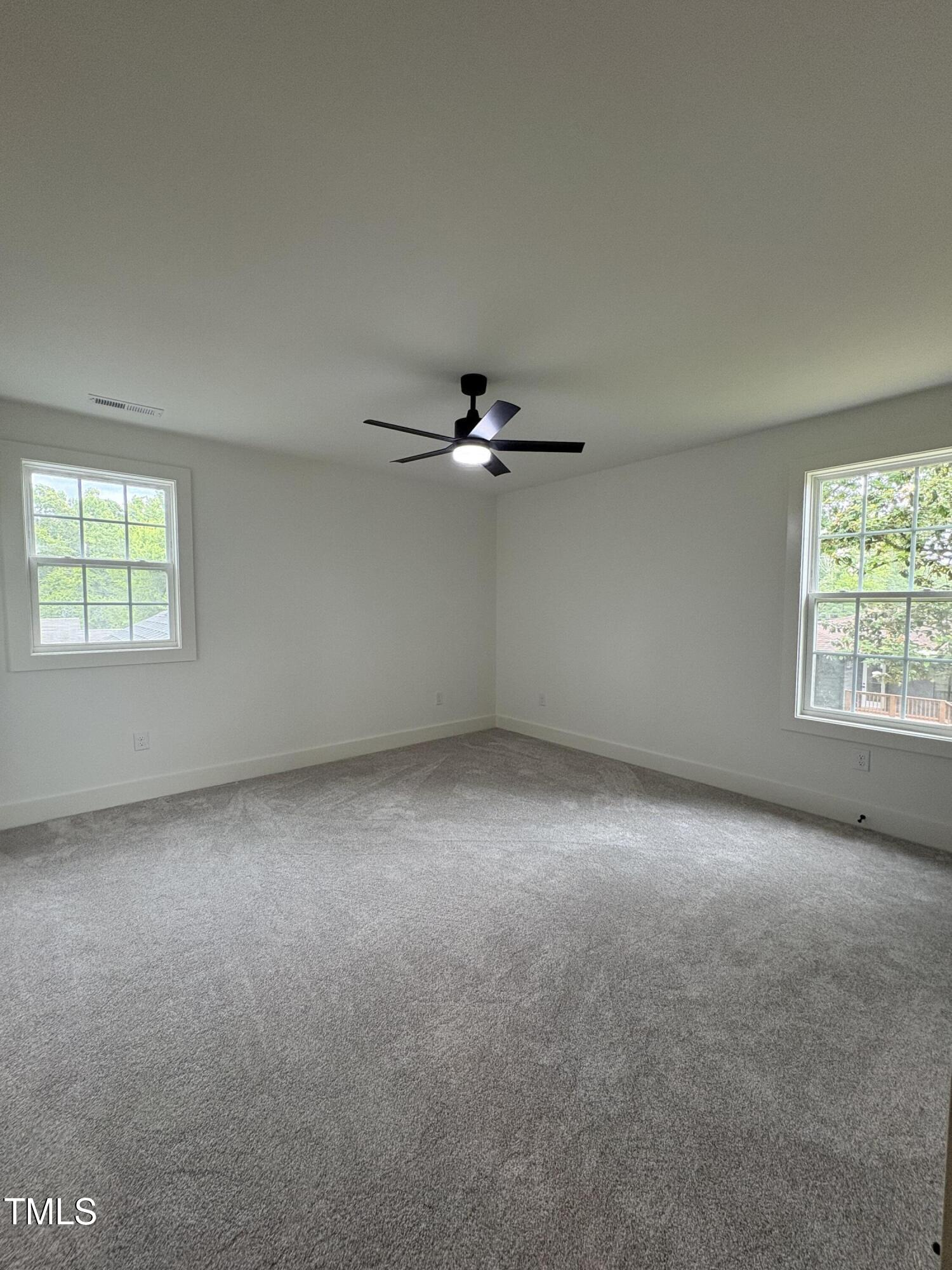 4511 Denfield Street Durham, NC 27704 - Photo 24 of 40 an empty room with windows and ceiling fan view