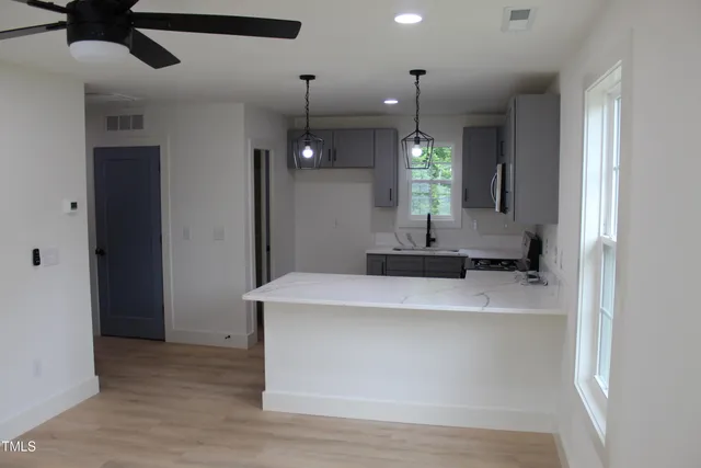 a view of a kitchen with a sink and a window