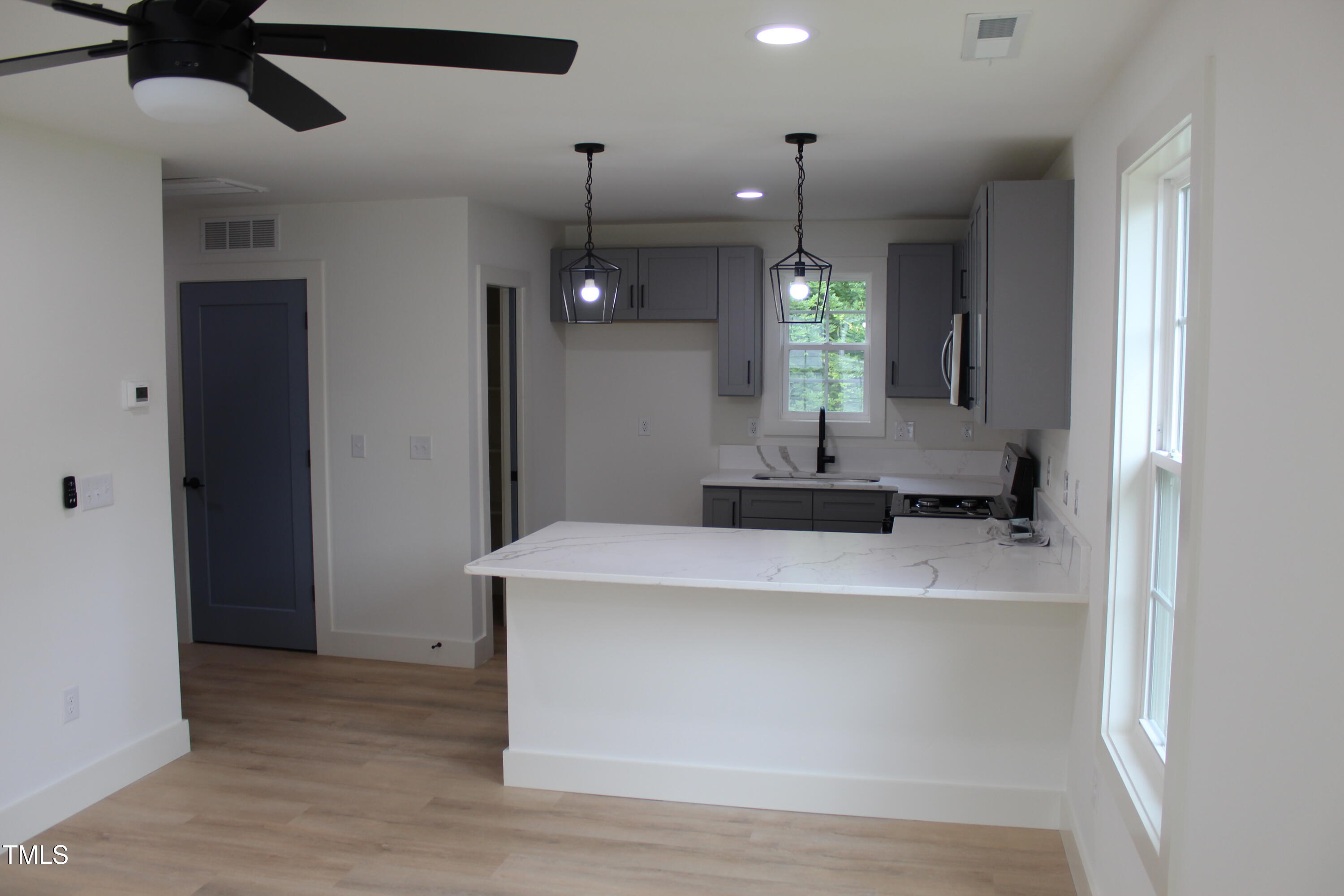 4511 Denfield Street Durham, NC 27704 - Photo 31 of 40 a view of a kitchen with a sink and a window