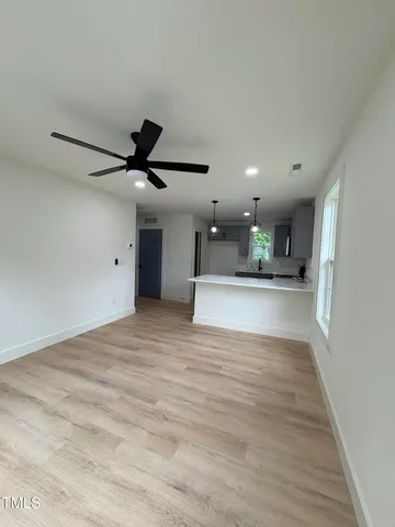 a view of kitchen and hall with wooden floor