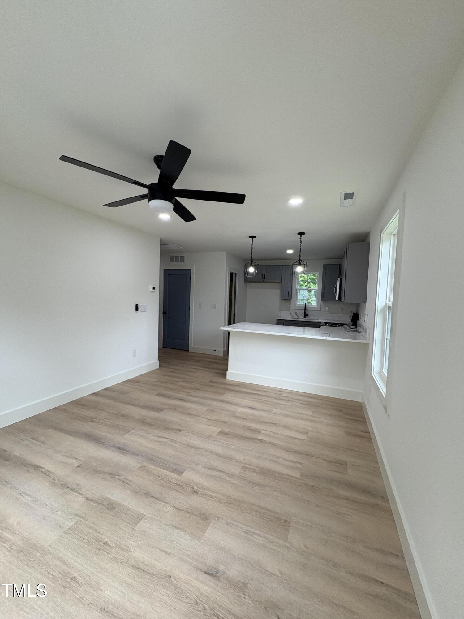 4511 Denfield Street Durham, NC 27704 - Photo 32 of 40 a view of kitchen and hall with wooden floor