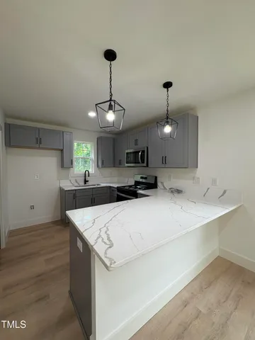 a large kitchen with stainless steel appliances kitchen island a large island in the center