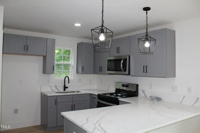 a kitchen with a sink and microwave