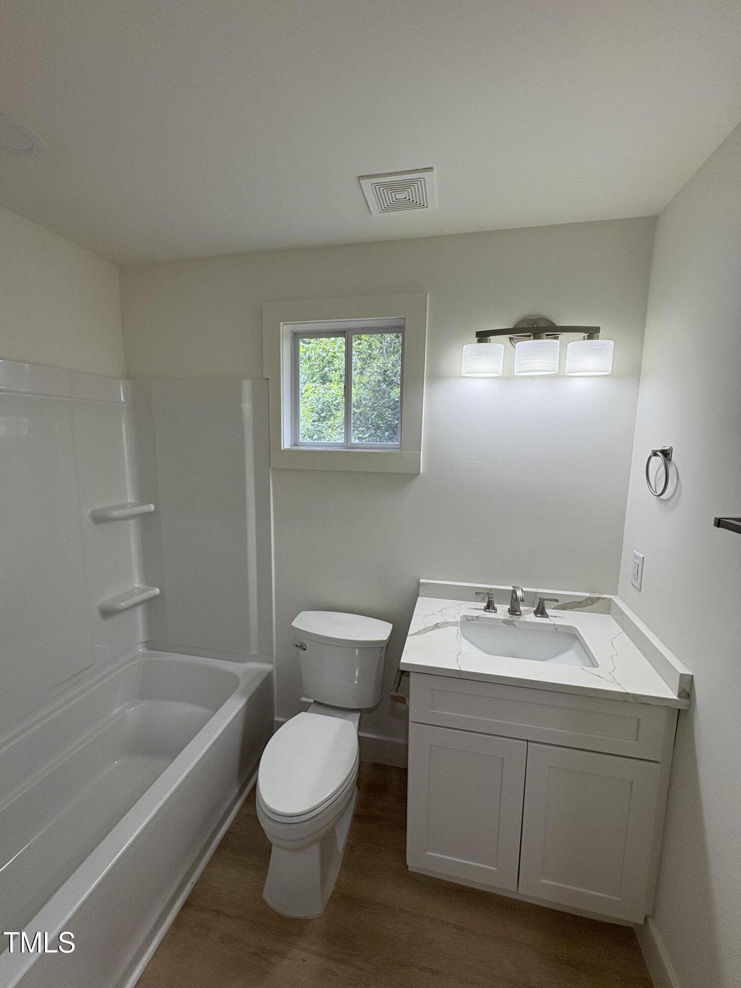 4511 Denfield Street Durham, NC 27704 - Photo 39 of 40 a bathroom with a sink toilet and bathtub