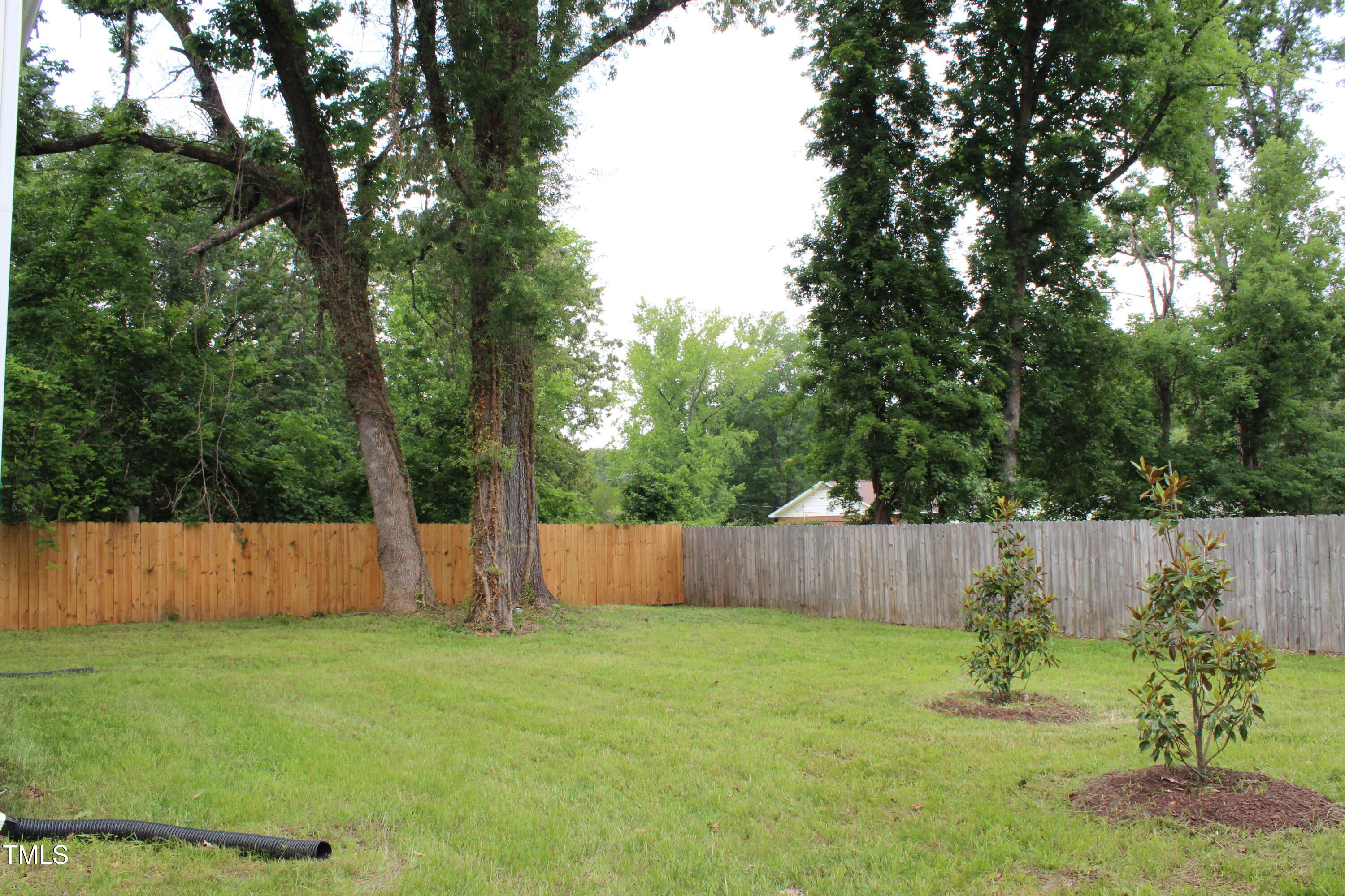 4511 Denfield Street Durham, NC 27704 - Photo 40 of 40 a backyard of a house with lots of green space