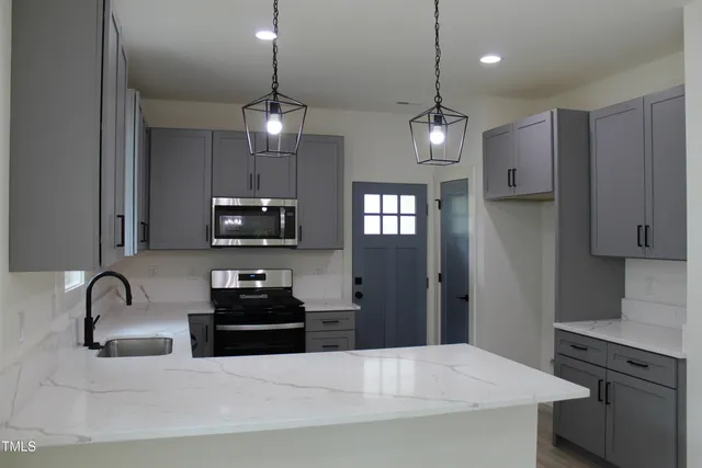 a kitchen with a refrigerator and a sink