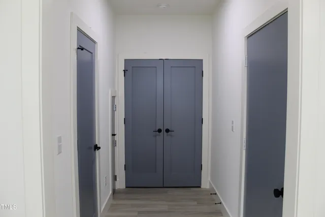 a view of a hallway with wooden floor