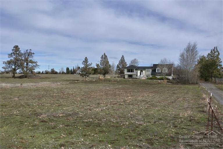 21645 Northeast Butler Market Road Bend, OR 97701 - Photo 10 of 13 a view of a field with trees in background