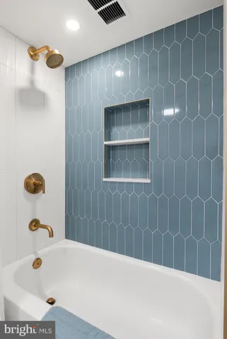 a bathroom with a tub and a shower