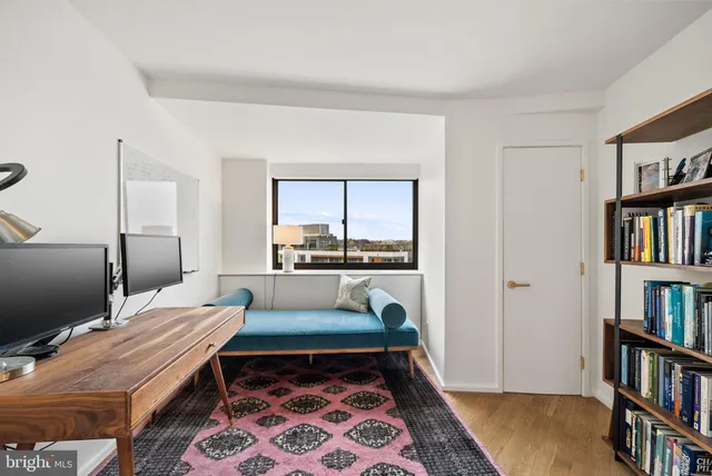 a bed room with a bed and a book shelf