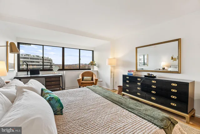 a bed room with a bed and a television