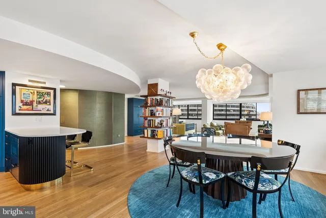 a kitchen with kitchen island a counter top space a sink stainless steel appliances and cabinets