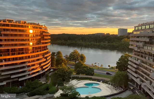 a living room with furniture and large windows