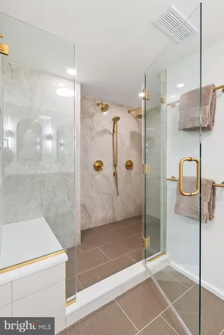 a bathroom with a shower and mirror