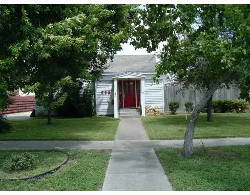 a front view of a house with yard and green space