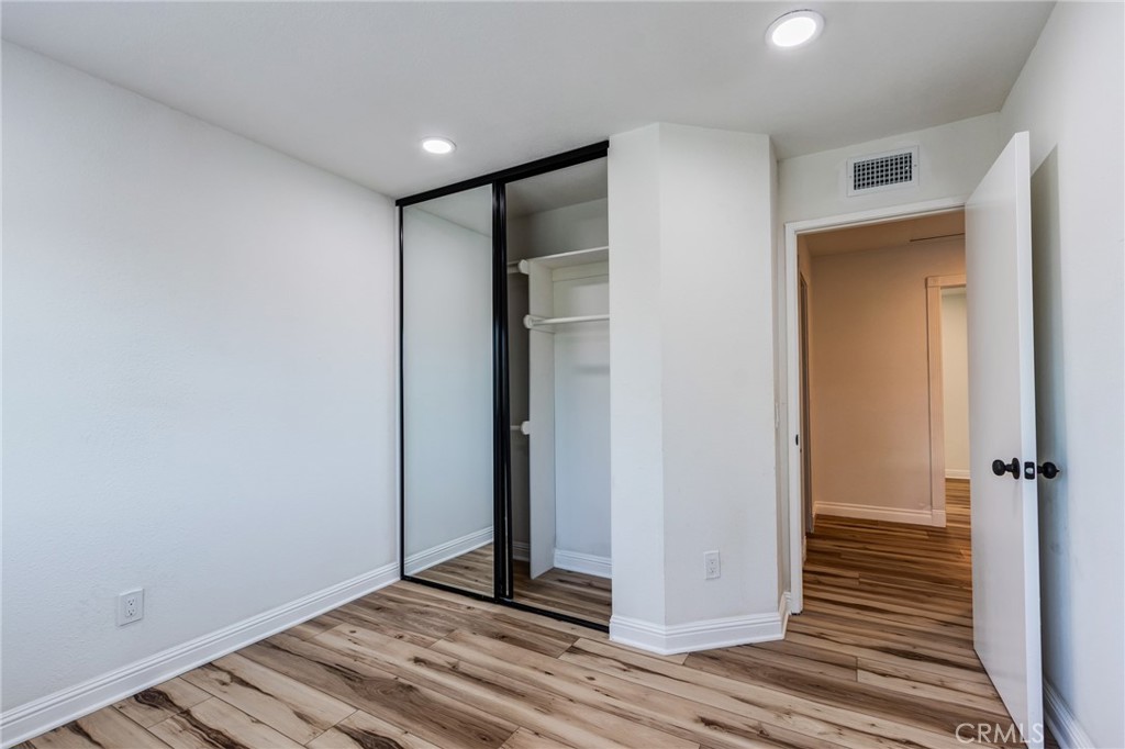 11721 Mt Sterling Court Rancho Cucamonga, CA 91737 - Photo 19 of 38 a view of a hallway with wooden floor and closet area