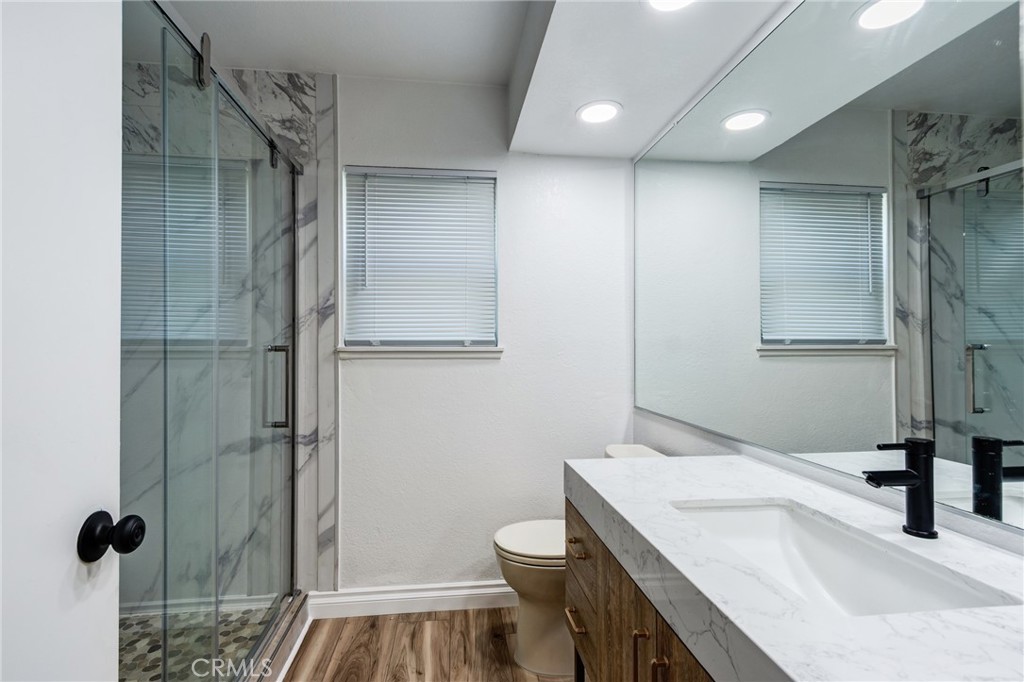 11721 Mt Sterling Court Rancho Cucamonga, CA 91737 - Photo 21 of 38 a bathroom with a sink a toilet and shower