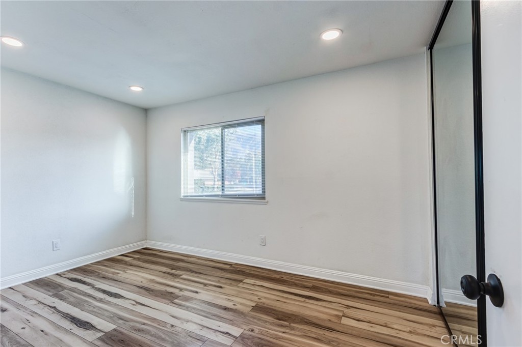 11721 Mt Sterling Court Rancho Cucamonga, CA 91737 - Photo 23 of 38 an empty room with wooden floor and windows