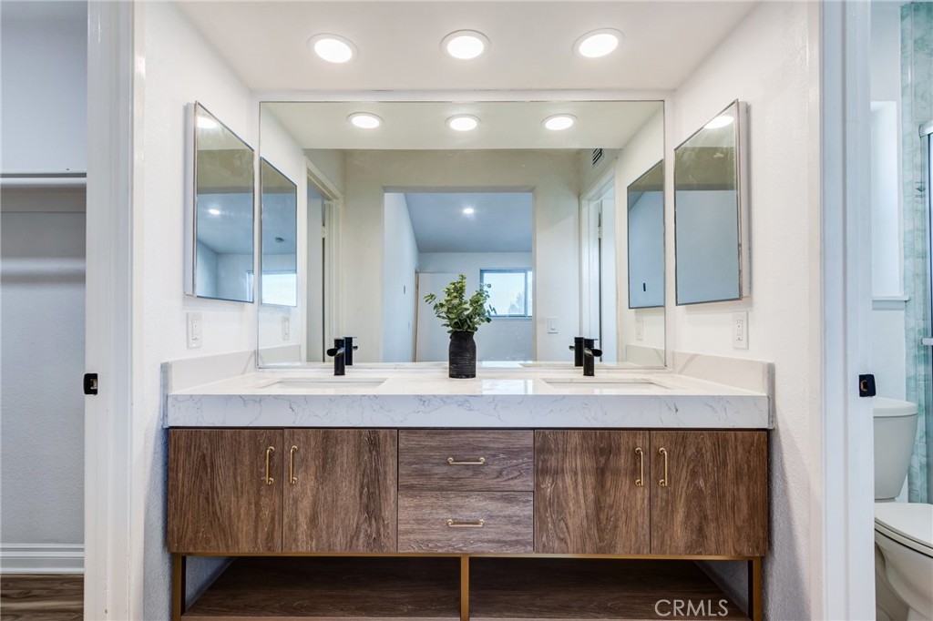 11721 Mt Sterling Court Rancho Cucamonga, CA 91737 - Photo 27 of 38 a bathroom with a granite countertop sink a mirror and a