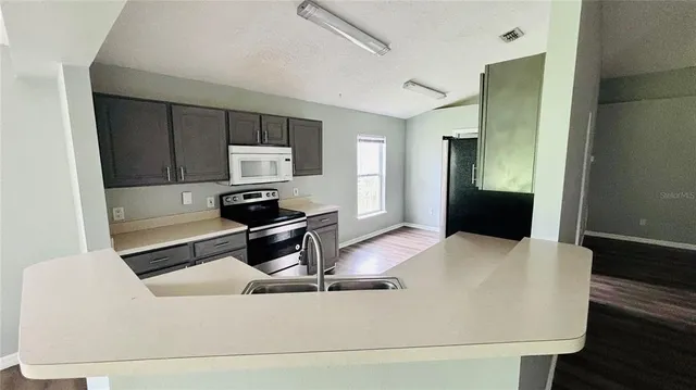 a kitchen with a table and chairs