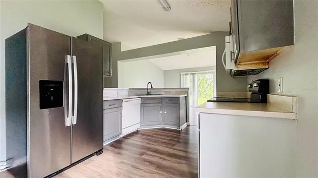 a kitchen with stainless steel appliances a refrigerator and a stove
