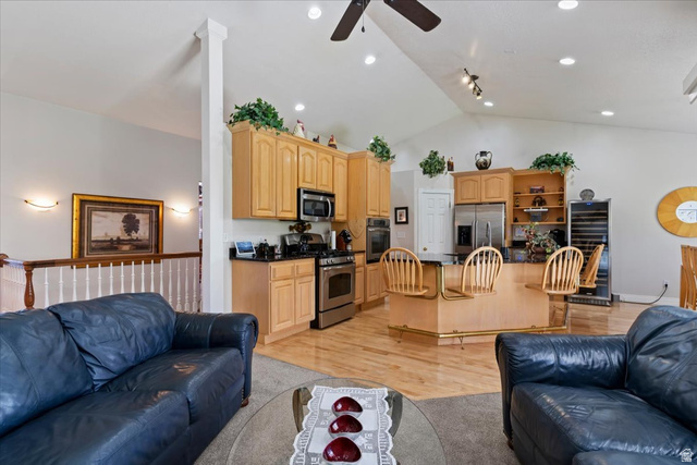 1924 North 2000th Street East Layton, UT 84040 - Photo 15 of 41 Living room featuring a ceiling fan, light wood-type flooring, lofted ceiling, and beverage cooler