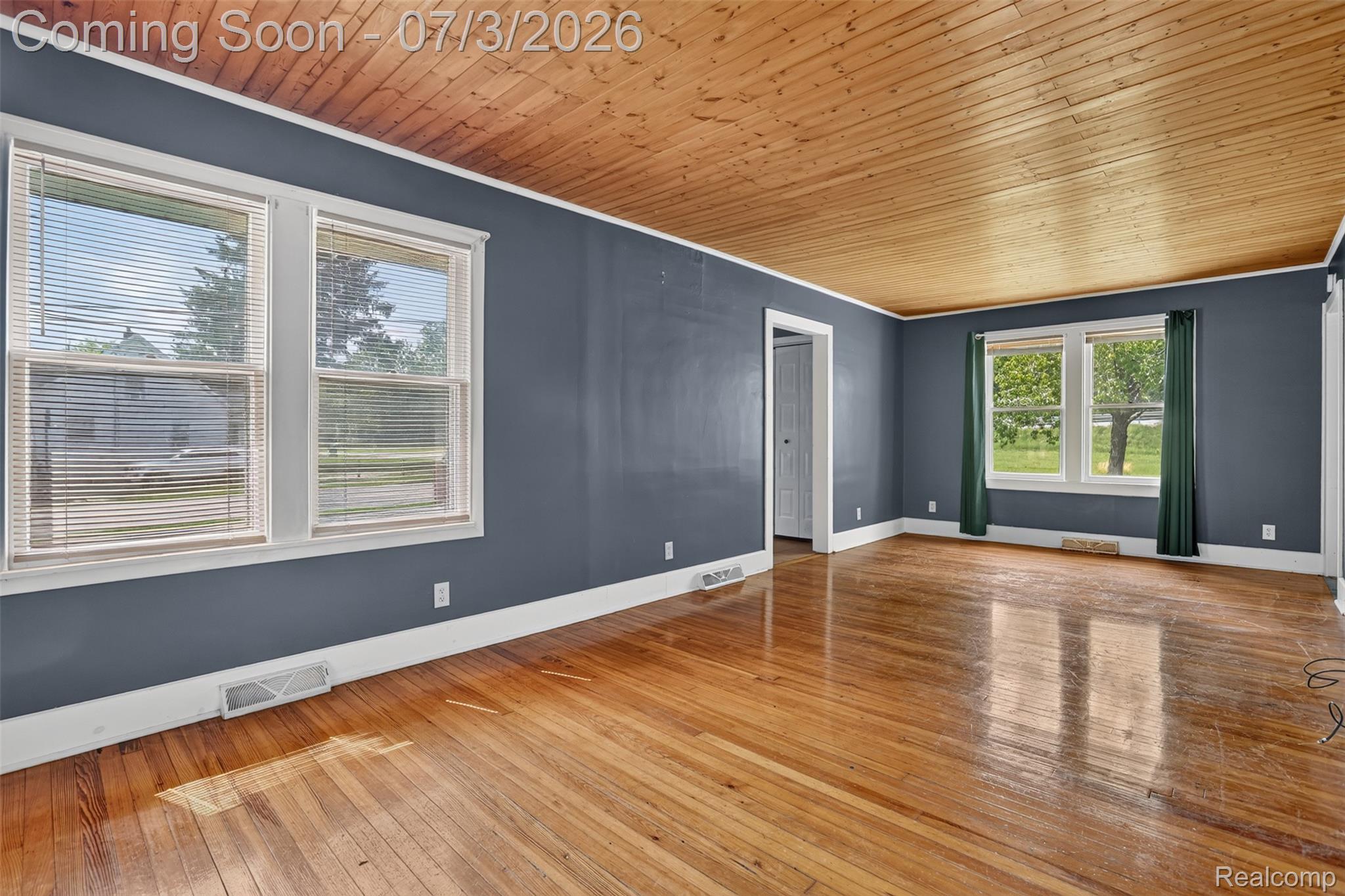 4322 Baker Road Bridgeport, MI 48722 - Photo 7 of 29 Wood-finish flooring throughout, complemented by a natural wood ceiling